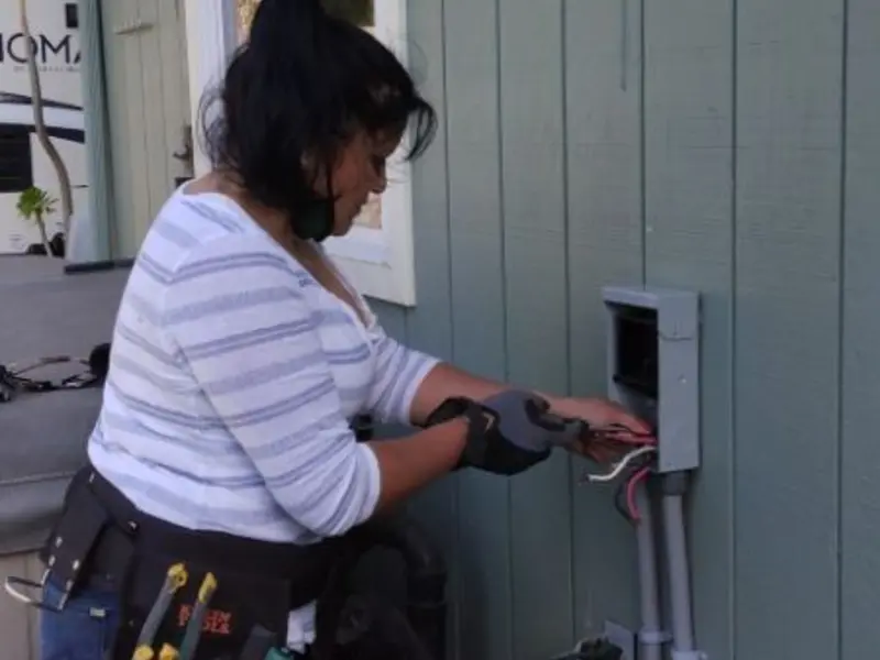 Licensed electrician wiring an exterior subpanel in Temple
