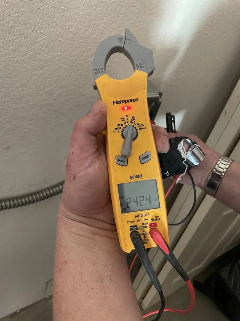 Voltage testing with clamp meter during Electrical Installation Services in Temple